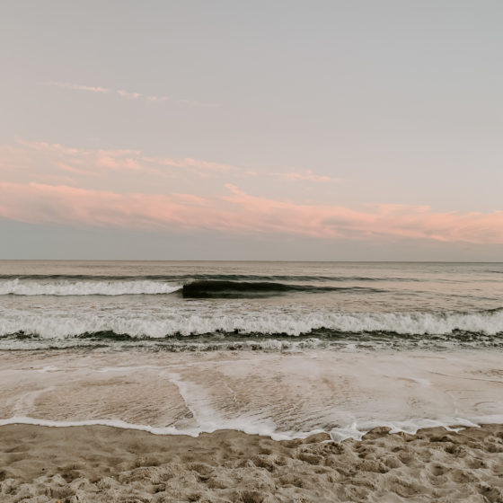 Landscape image of the shore and ocean at sunset
