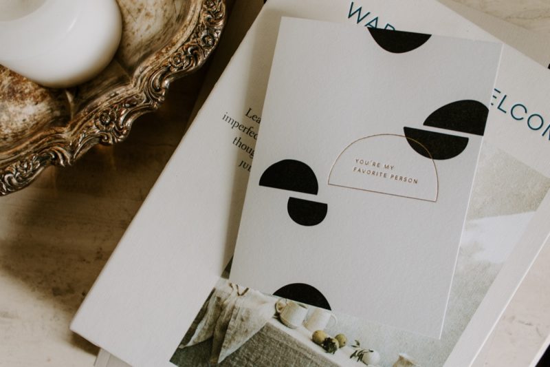 overhead image of a greeting card on a stack of books